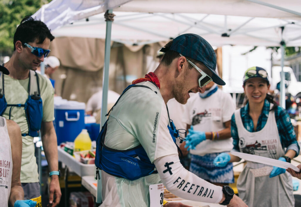 Jeff Colt helps himself to food at an aid station at the Western States Endurance Run.