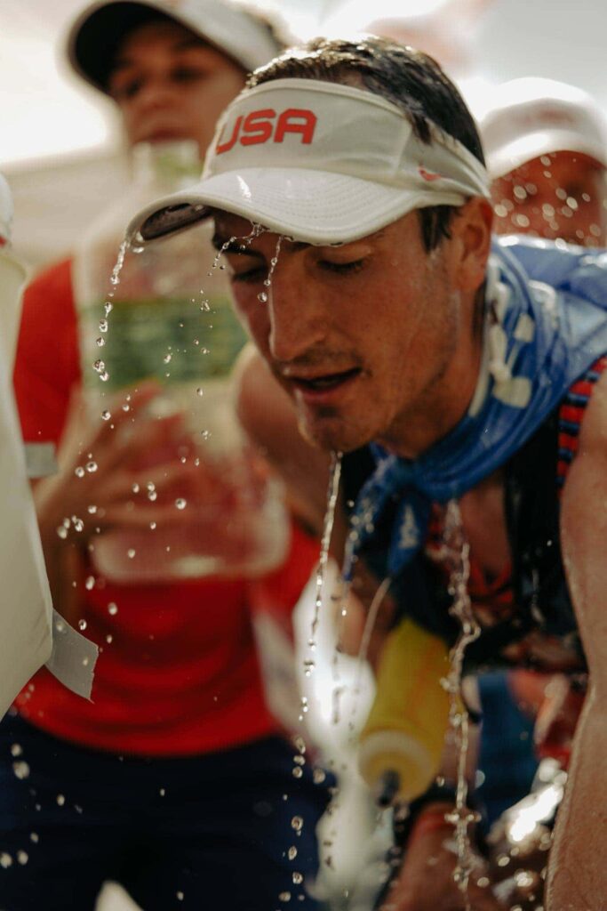 Adam Peterman gets water poured on him at the team aid station. 