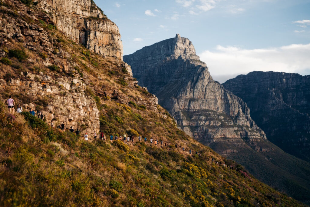 Table mountain looming over runners making their way around Lion's Head 