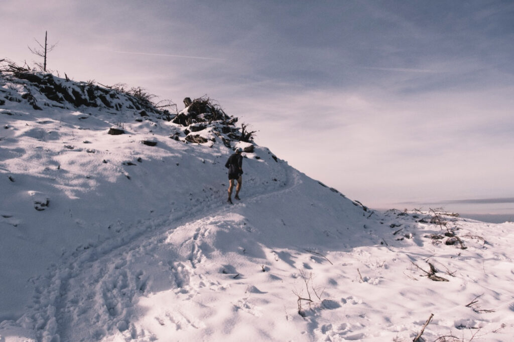 Rich Lockwood runs across a snowy fire road on top of tiger mountain