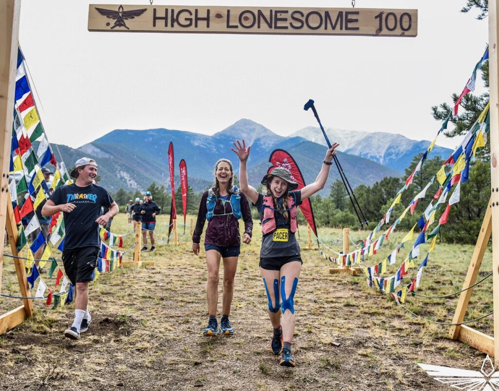 Sarah paced into the finish line by her two children at High Lonesome in 2022 - coming full circle.